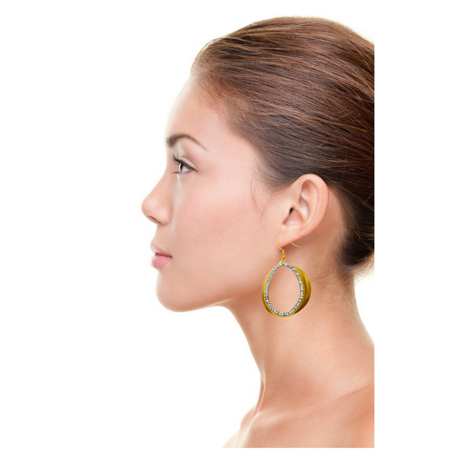 Stunning gold crystal earrings on a beautiful model. Evening look and a standout piece