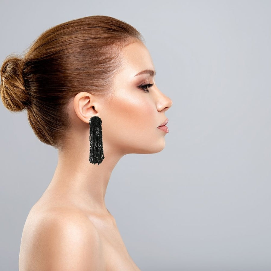 Model wearing the black glass beaded raindrop earrings. Standout piece, and evening wear.