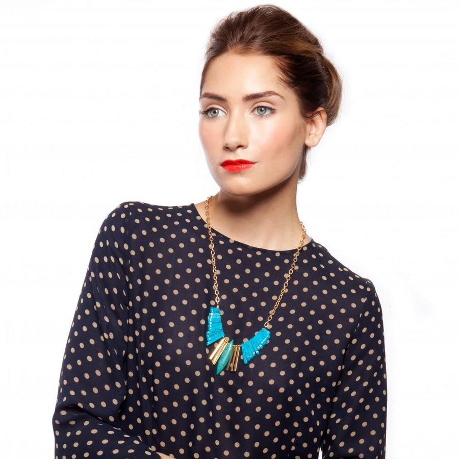 woman wearing this stunning turquoise and gold chain. 